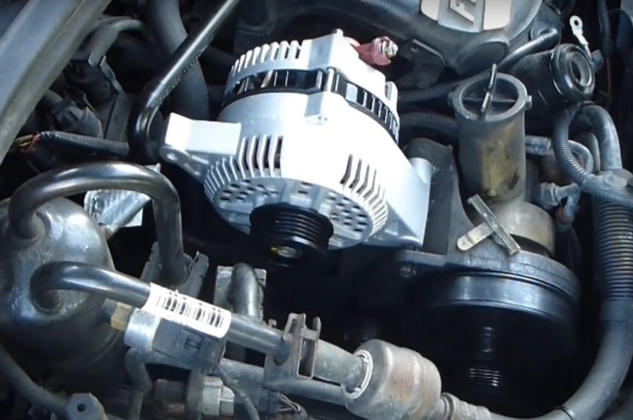 New automobile alternator being installed by mobile mechanic in Santa Ana, California.