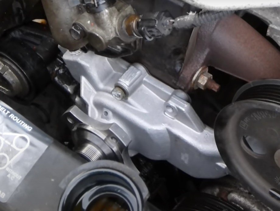 Mobile mechanic changing a bad water pump on a vehicle in Santa Ana, California.